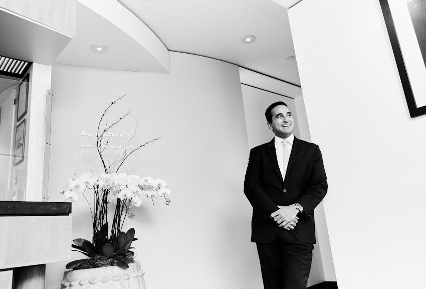 Dr. Dugar leaning against a wall