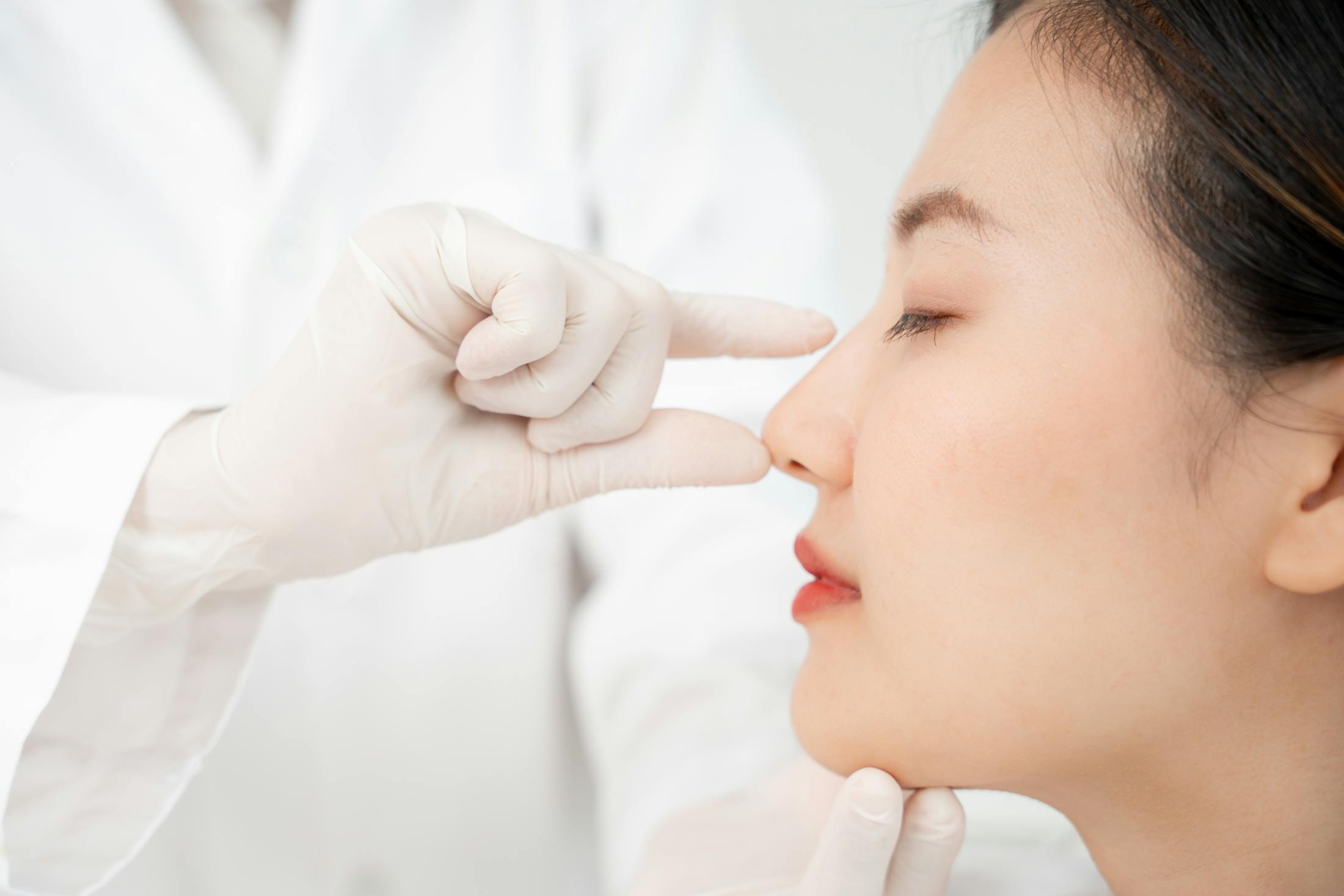 An asian woman getting her nose seen to