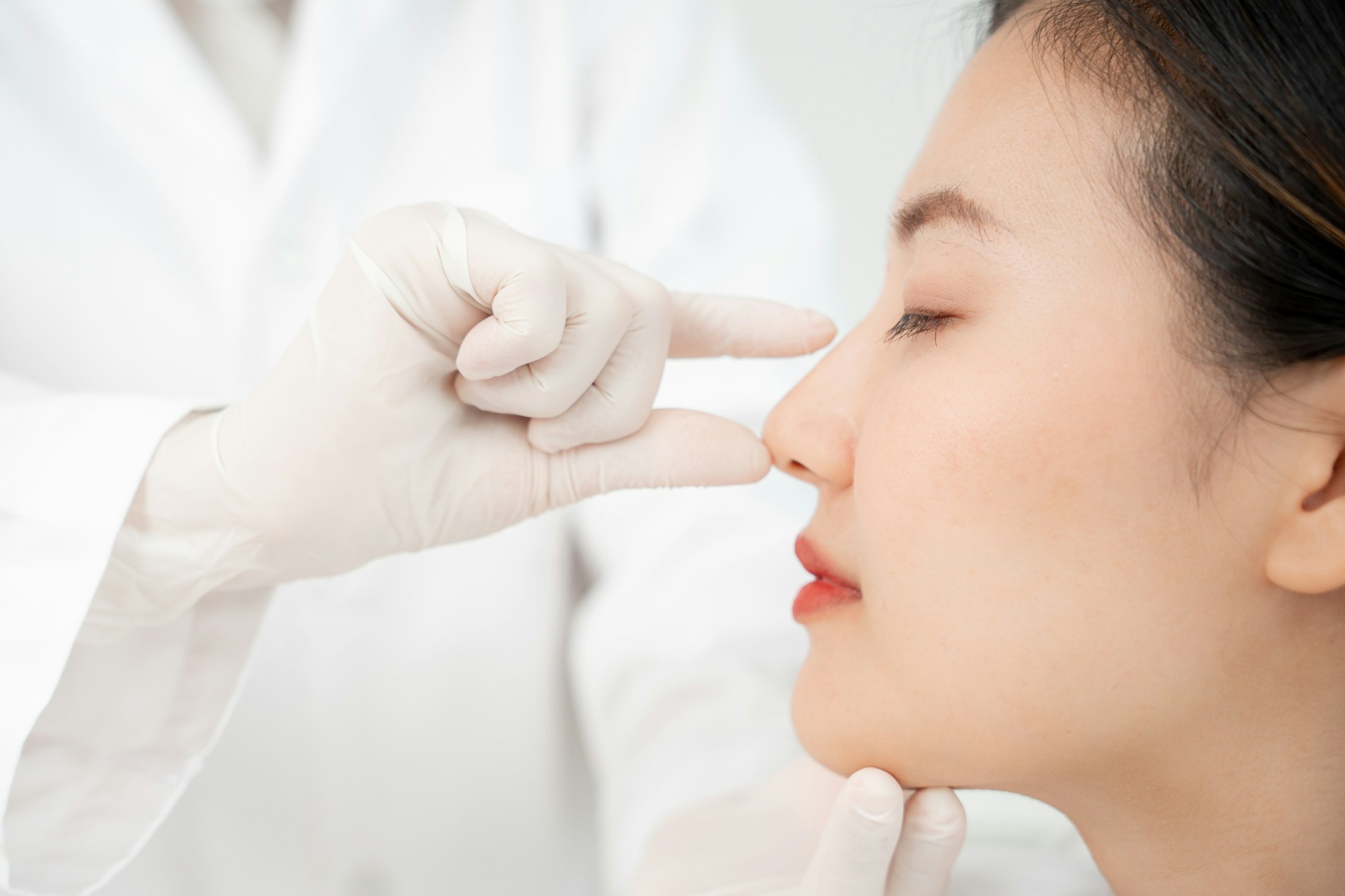 An asian woman getting her nose seen to