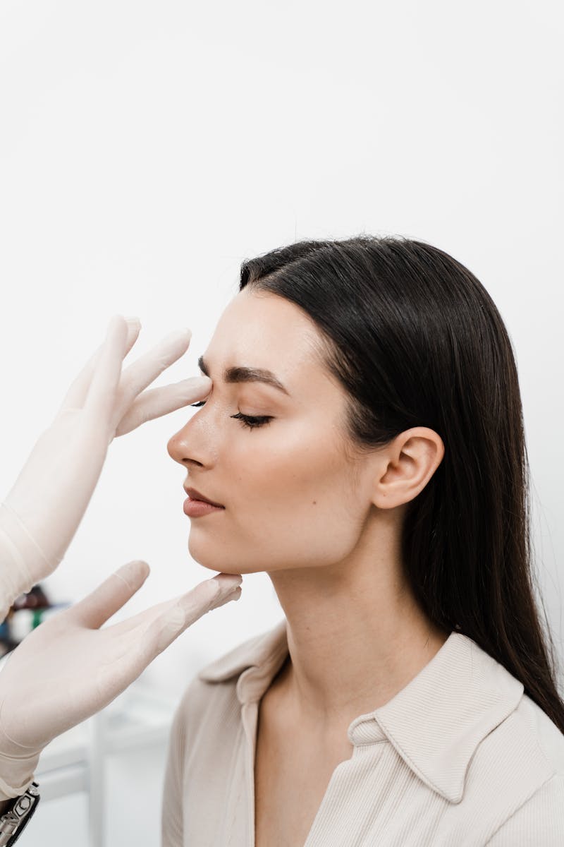 A doctor looking at a woman's nose
