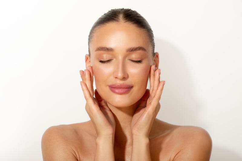 Woman touching both cheeks