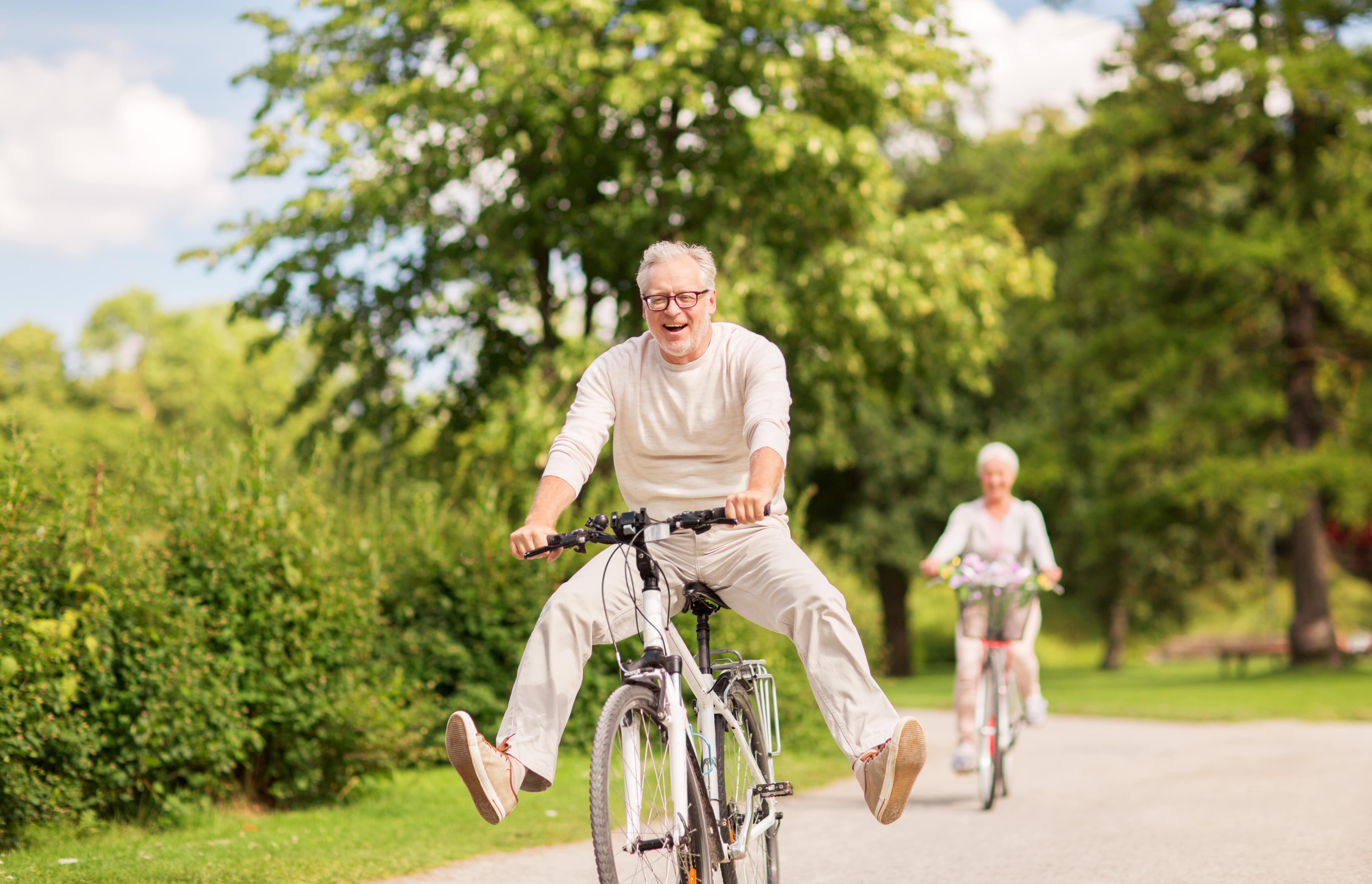 An older man cycling in the park