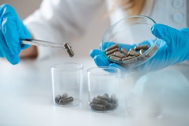 A scientist assessing multiple faecal capsules (crapsules)