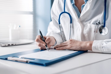 A doctor writing medical notes