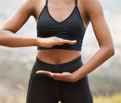 A woman with good gut health dressed in running gear