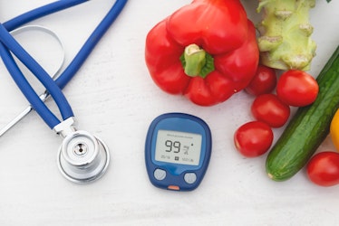 A blood pressure monitor next to some vegetables