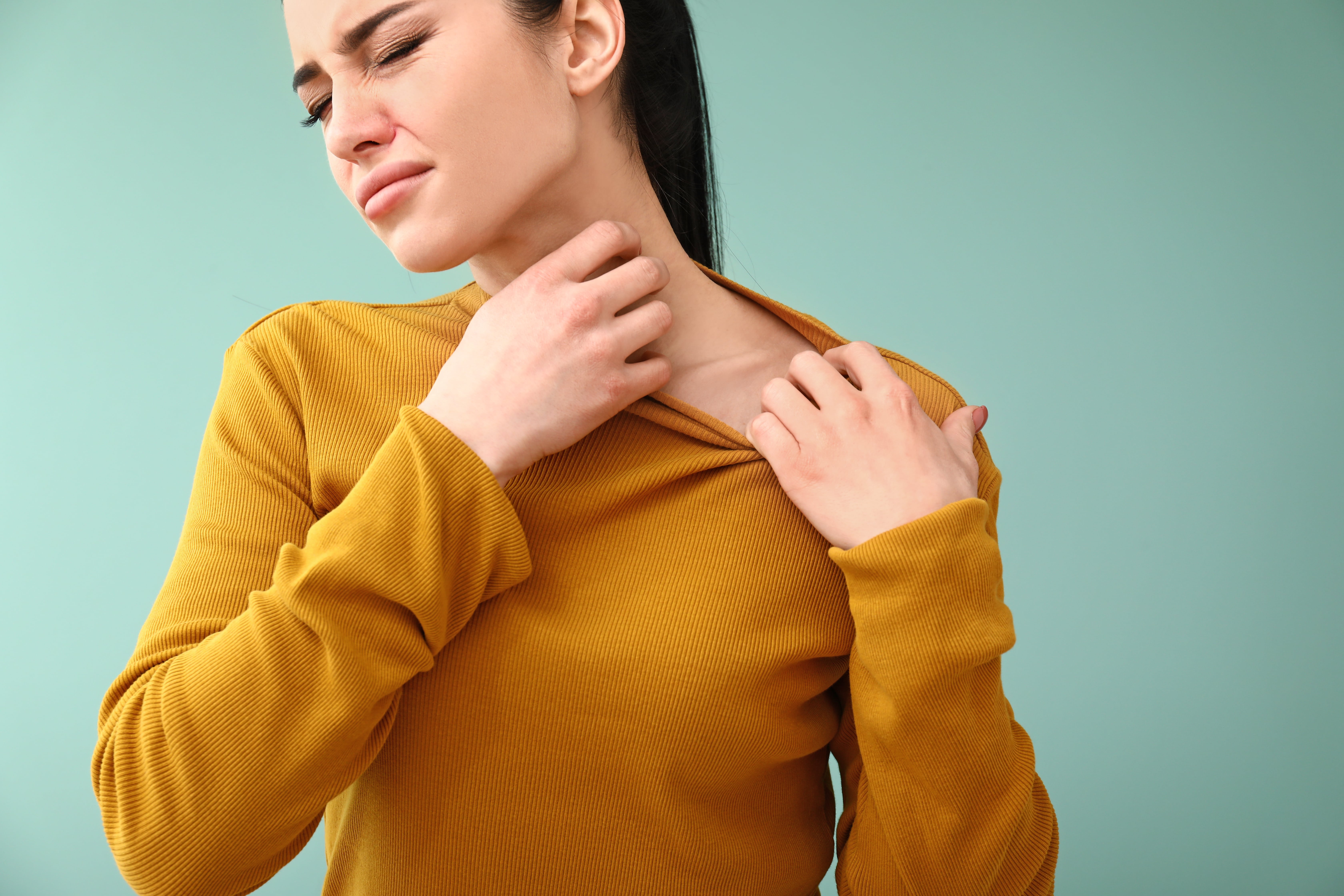 A lady suffering from allergies that are affecting her throat