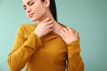 A lady suffering from allergies that are affecting her throat