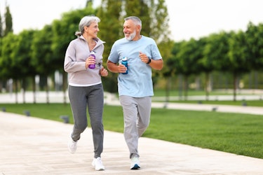 Middle aged couple running in a park