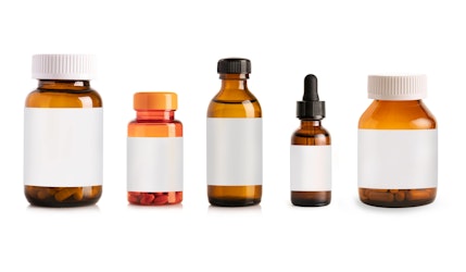 Different types of brown glass and plastic medicine bottles with blank labels, showing pill containers, liquid solutions, and a dropper bottle used for supplements such as NAD+, prescription or over-the-counter medications.