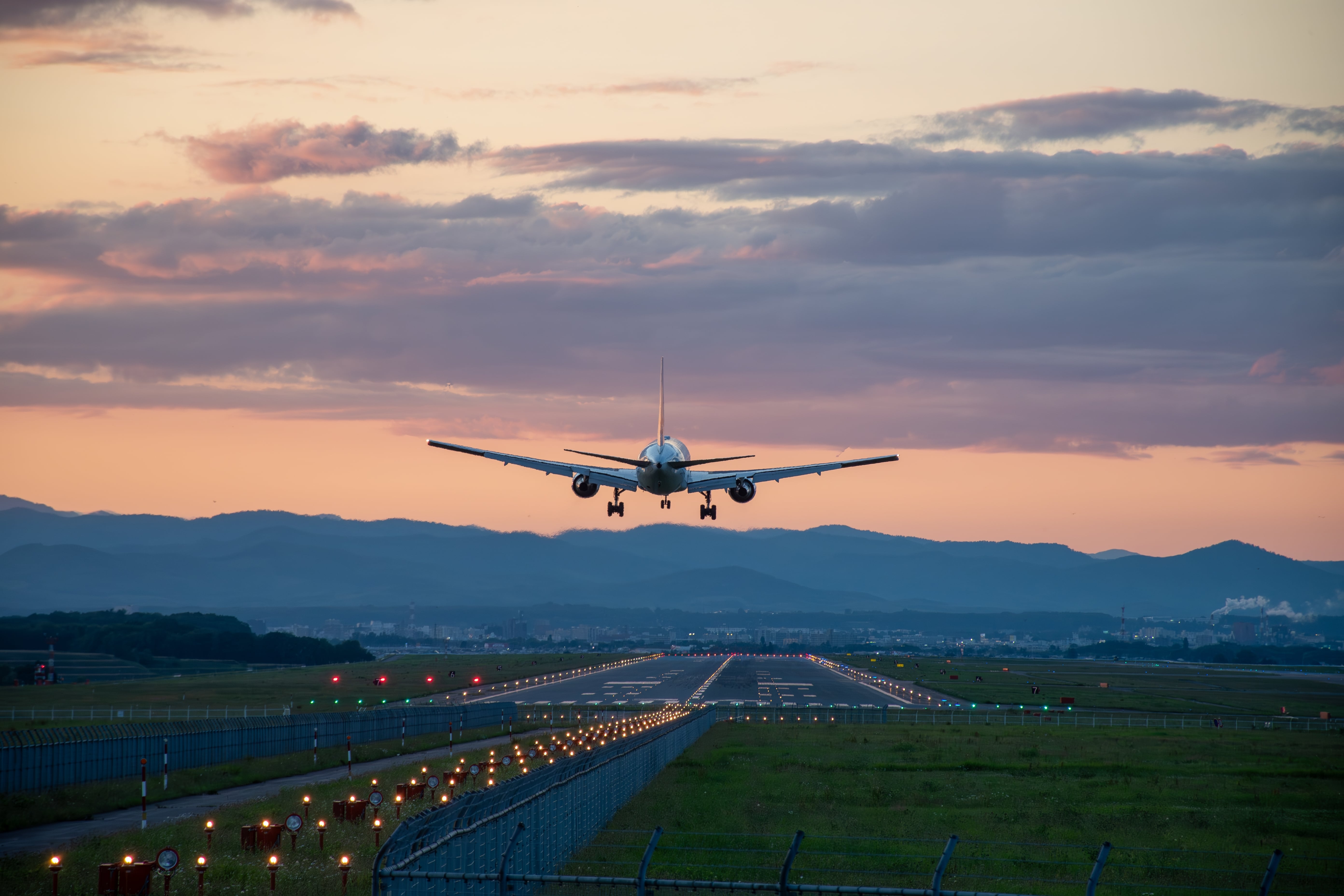 A commercial aeroplane landing at sunset, symbolising frequent travel and the importance of maintaining health, energy and wellbeing on the move.