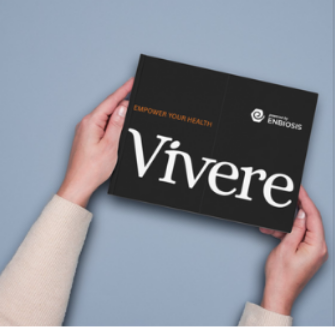 Hands holding a sleek black Vivere gut health test kit box against a pale blue background