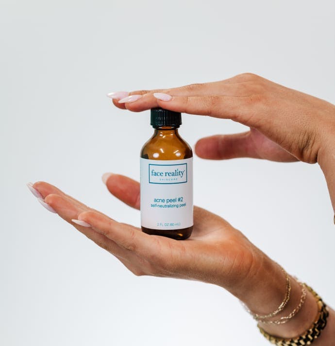 woman's hands holding a skincare product