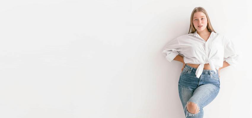 Woman posing against wall