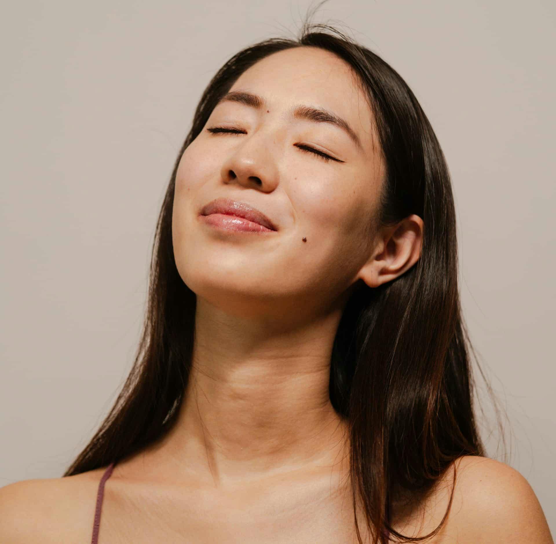 Woman smiling with eyes closed