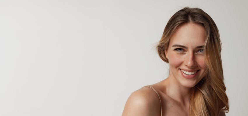 Woman smiling touching face