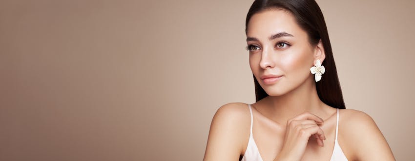 woman in white flower earrings