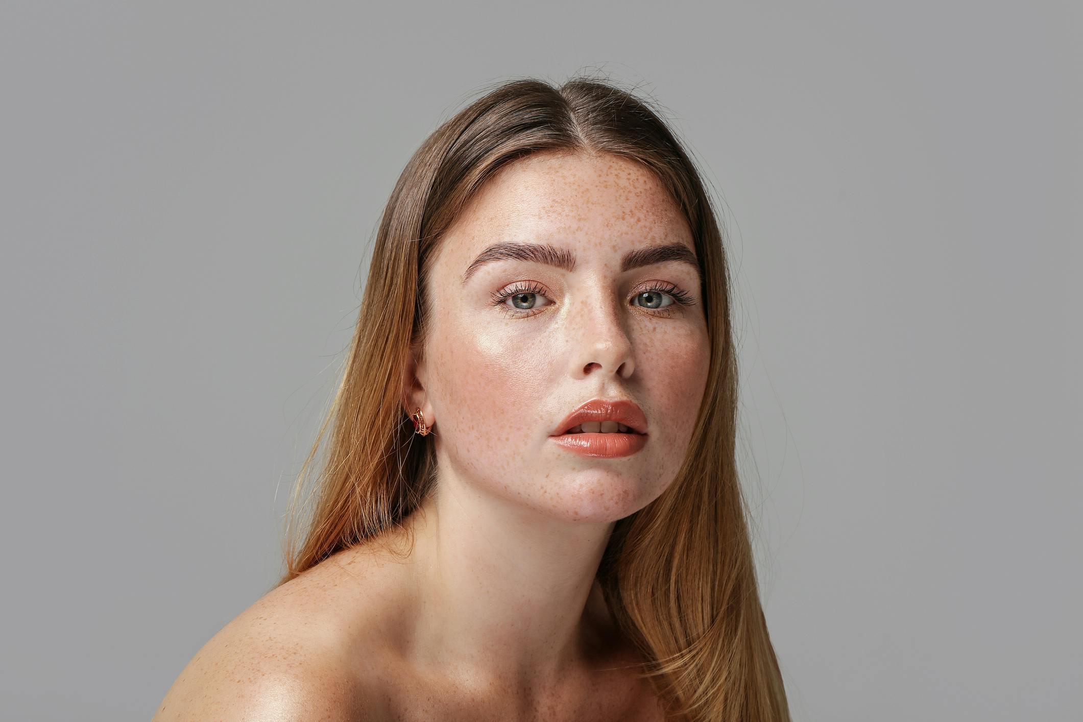 brunette young woman with freckles