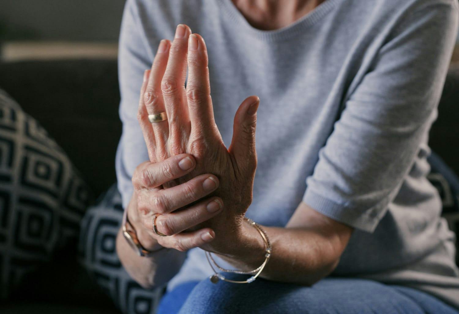 Woman holding her own hand