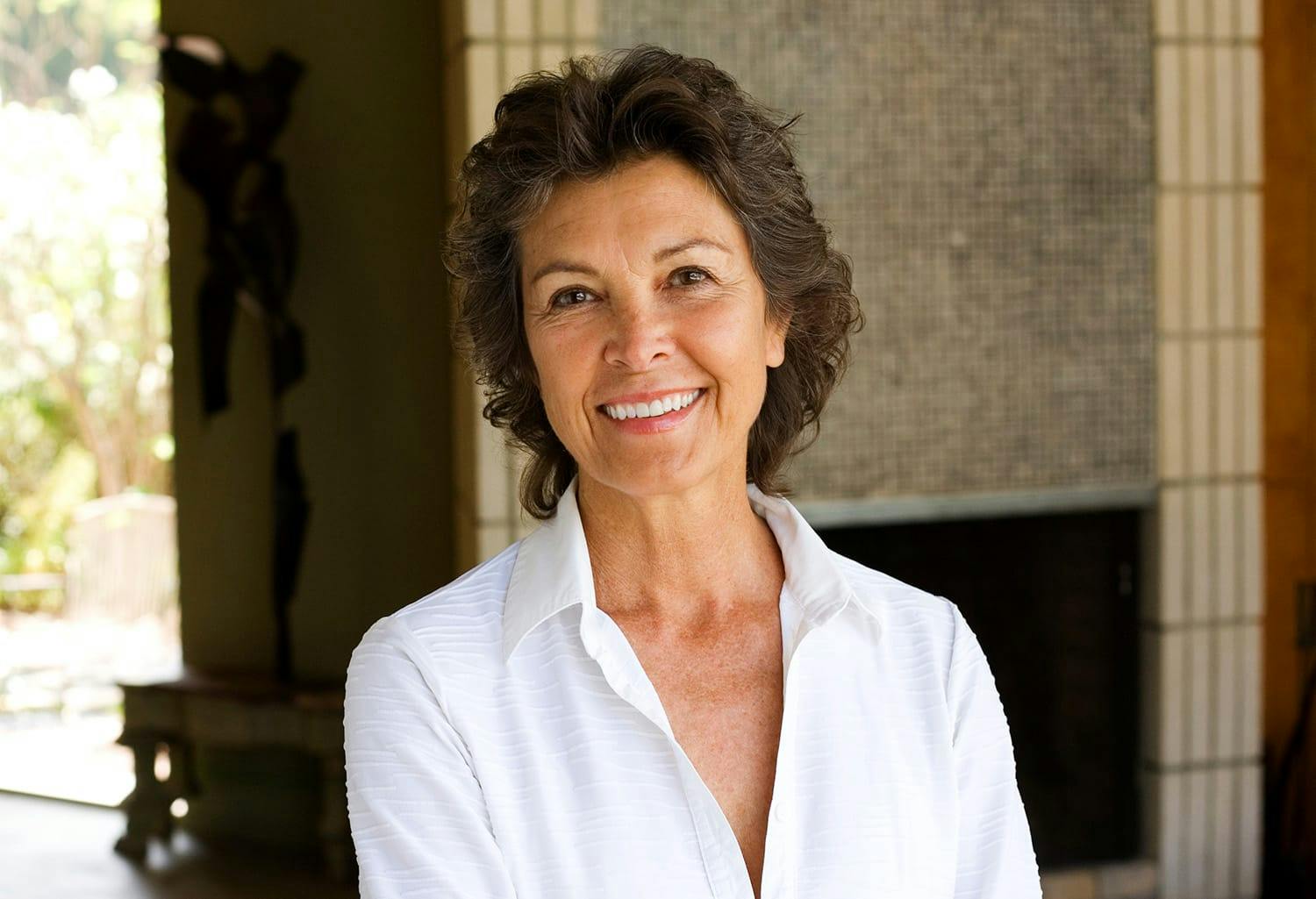 Woman in a white shirt, smiling