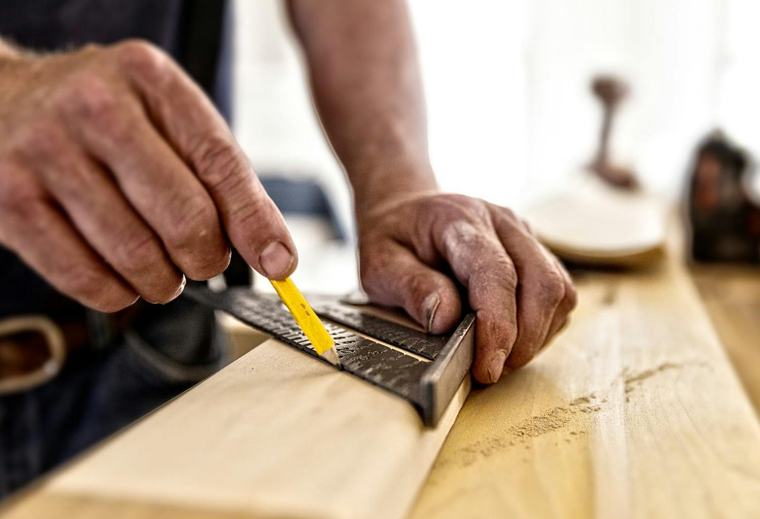 Man measuring a piece of wood