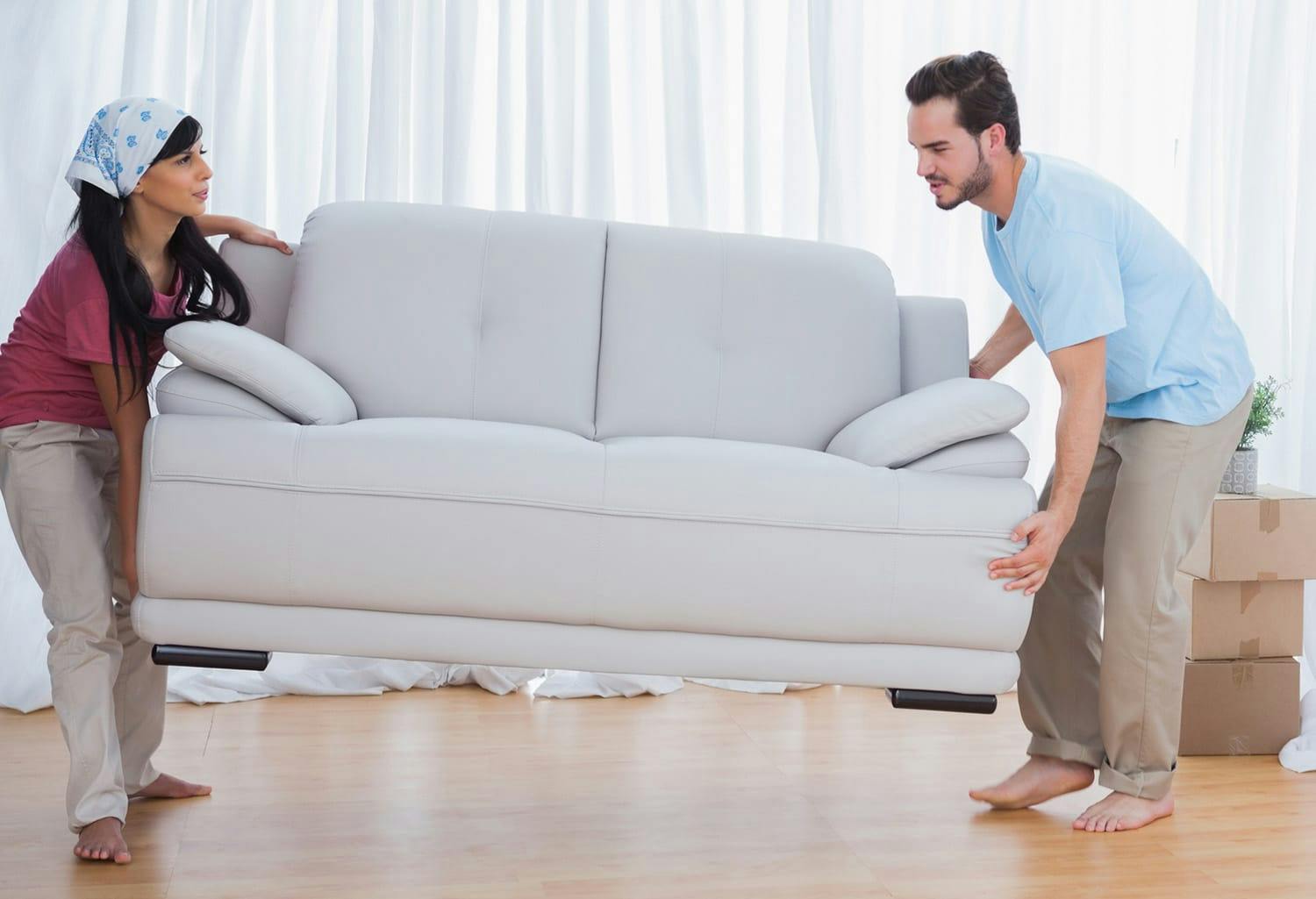 Man and woman moving a couch