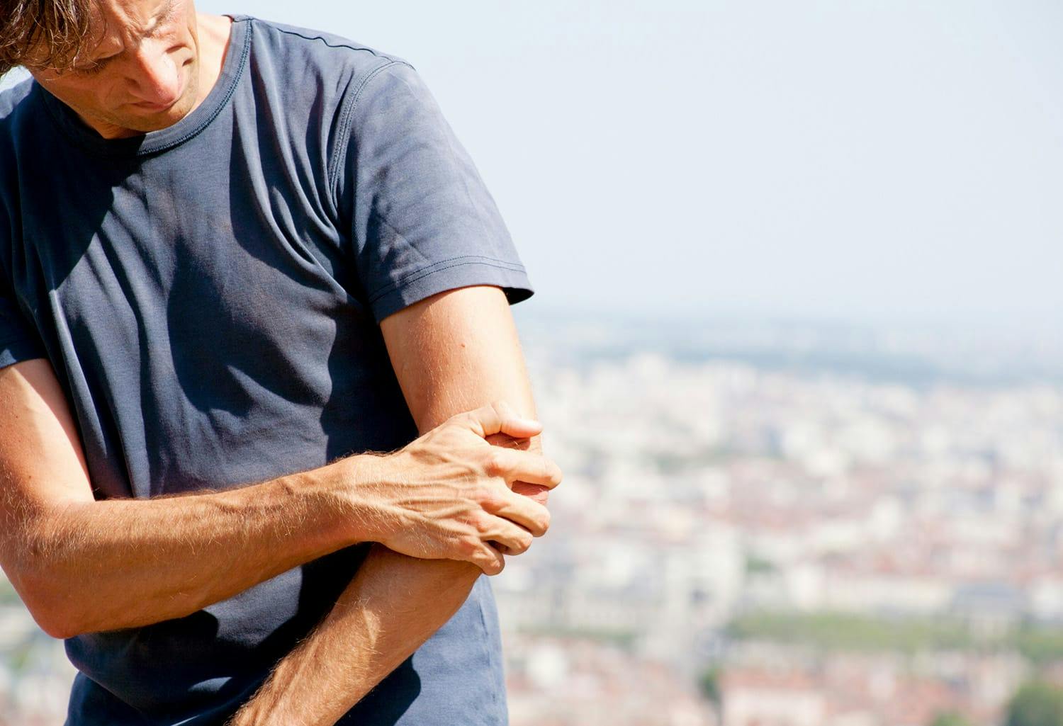 Man holding his elbow