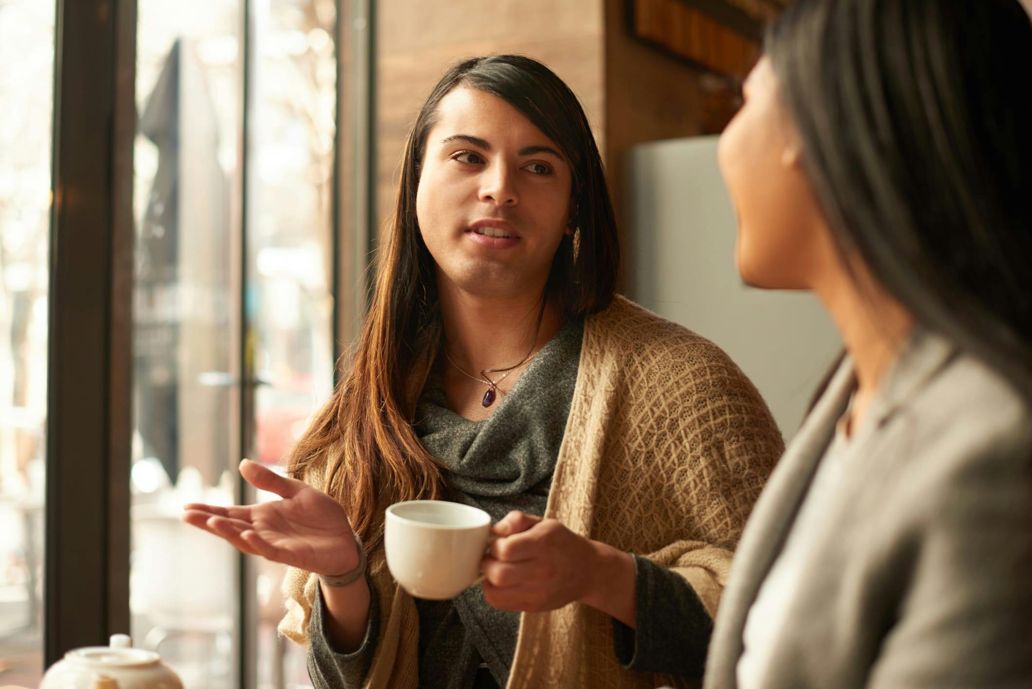 Two people having coffee together