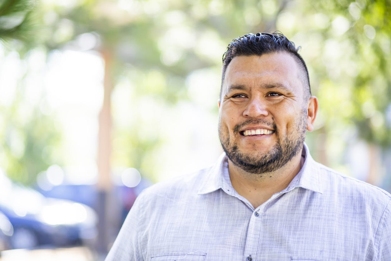 Man with black hair smiling
