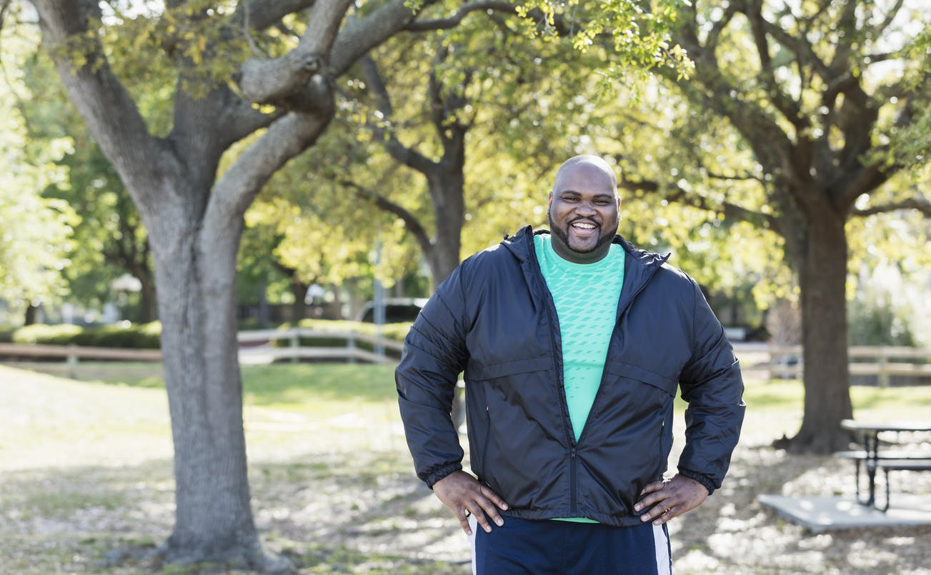 Man in a jacket standing in a park