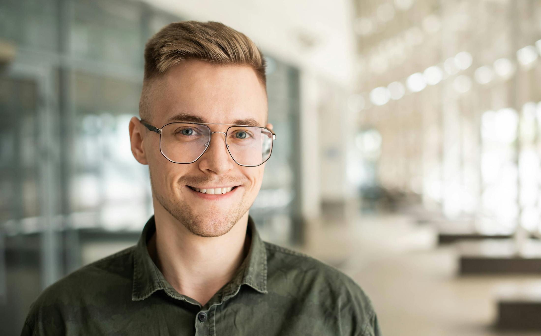 man with haircut and reading glasses