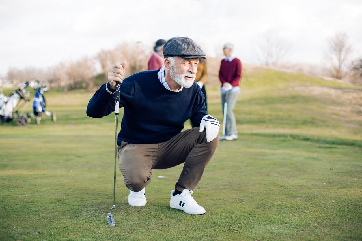 older man playing golf