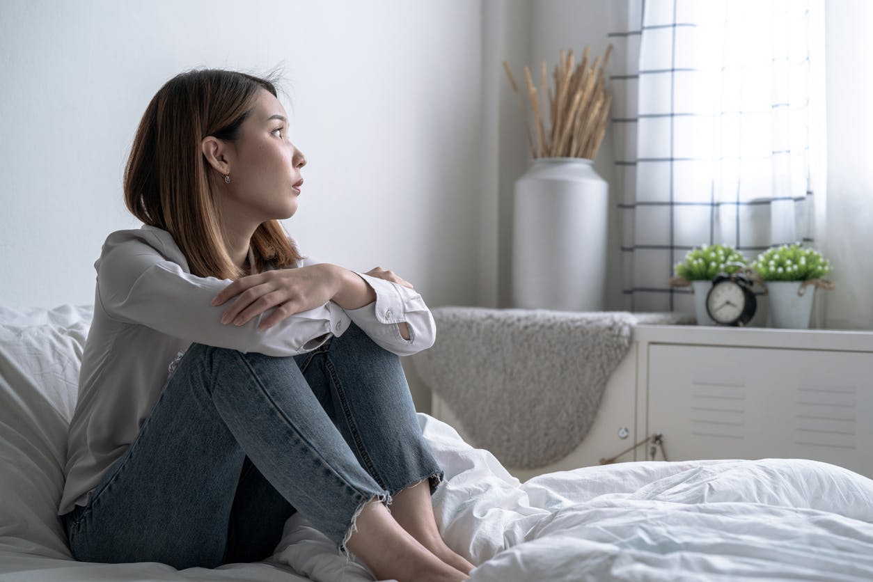 woman thinking in her room