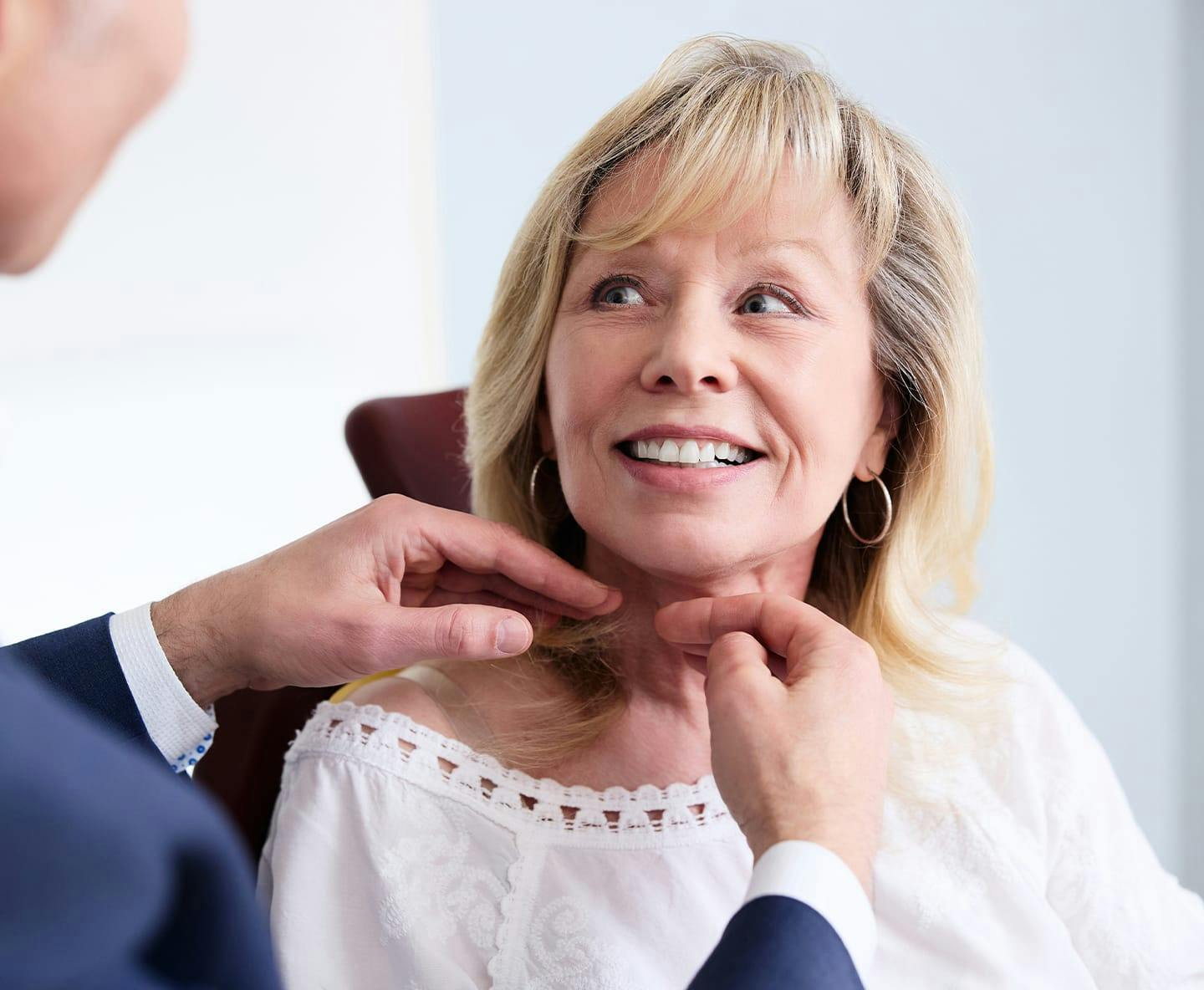 Woman getting her face examined