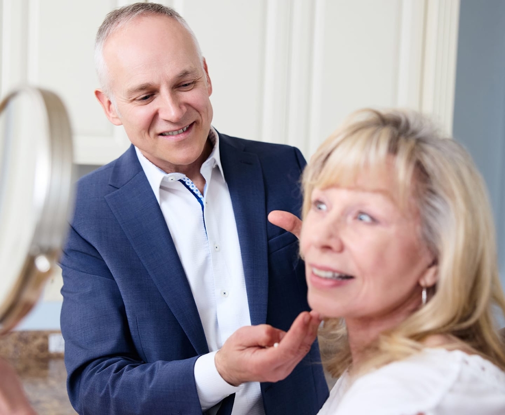 Dr. Fechner with client checking her facial structure