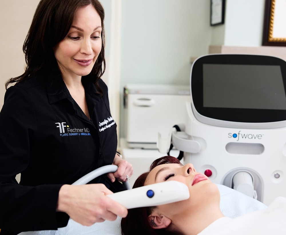 patient laying down with sofwave machine on her face