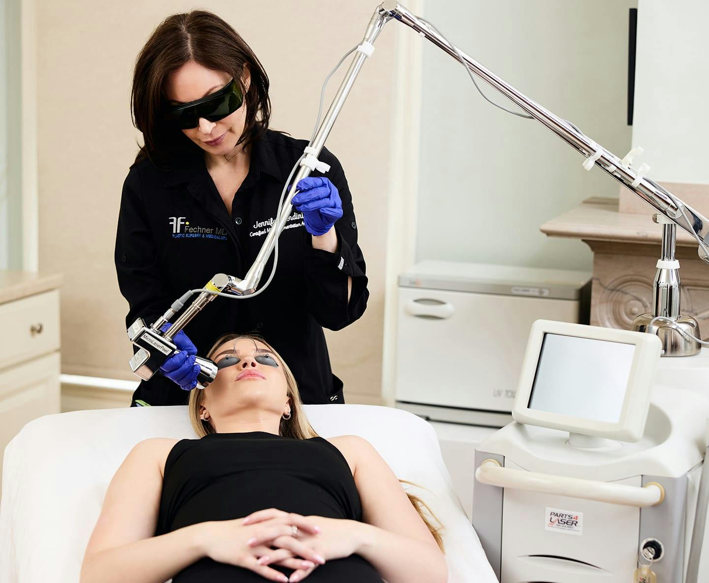 patient laying down while nurse told machine to her cheek