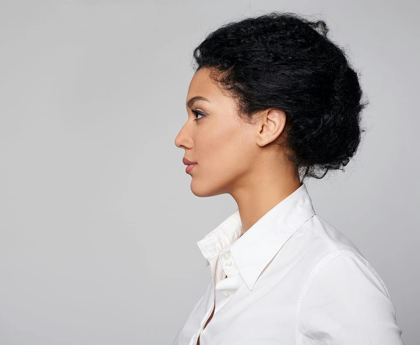 side profile of woman in white collared shirt