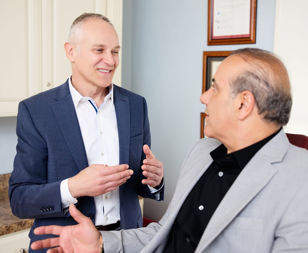 Dr. Fechner speaking to patient while he sits in chair