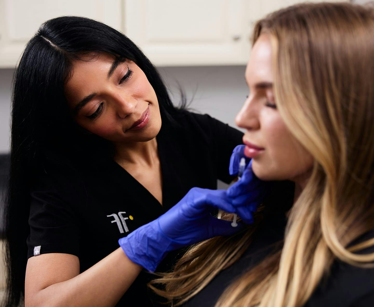 nurse injecting into patient's face
