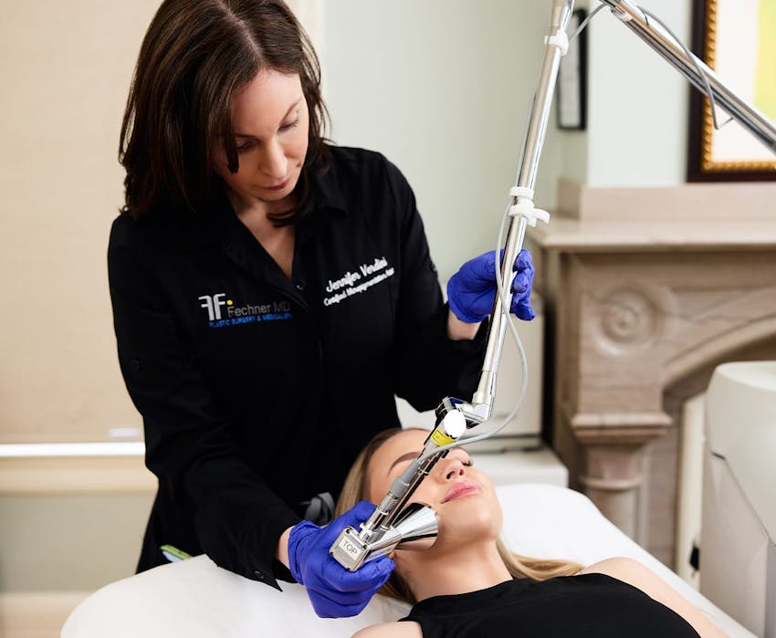 nurse giving patient facial procedure