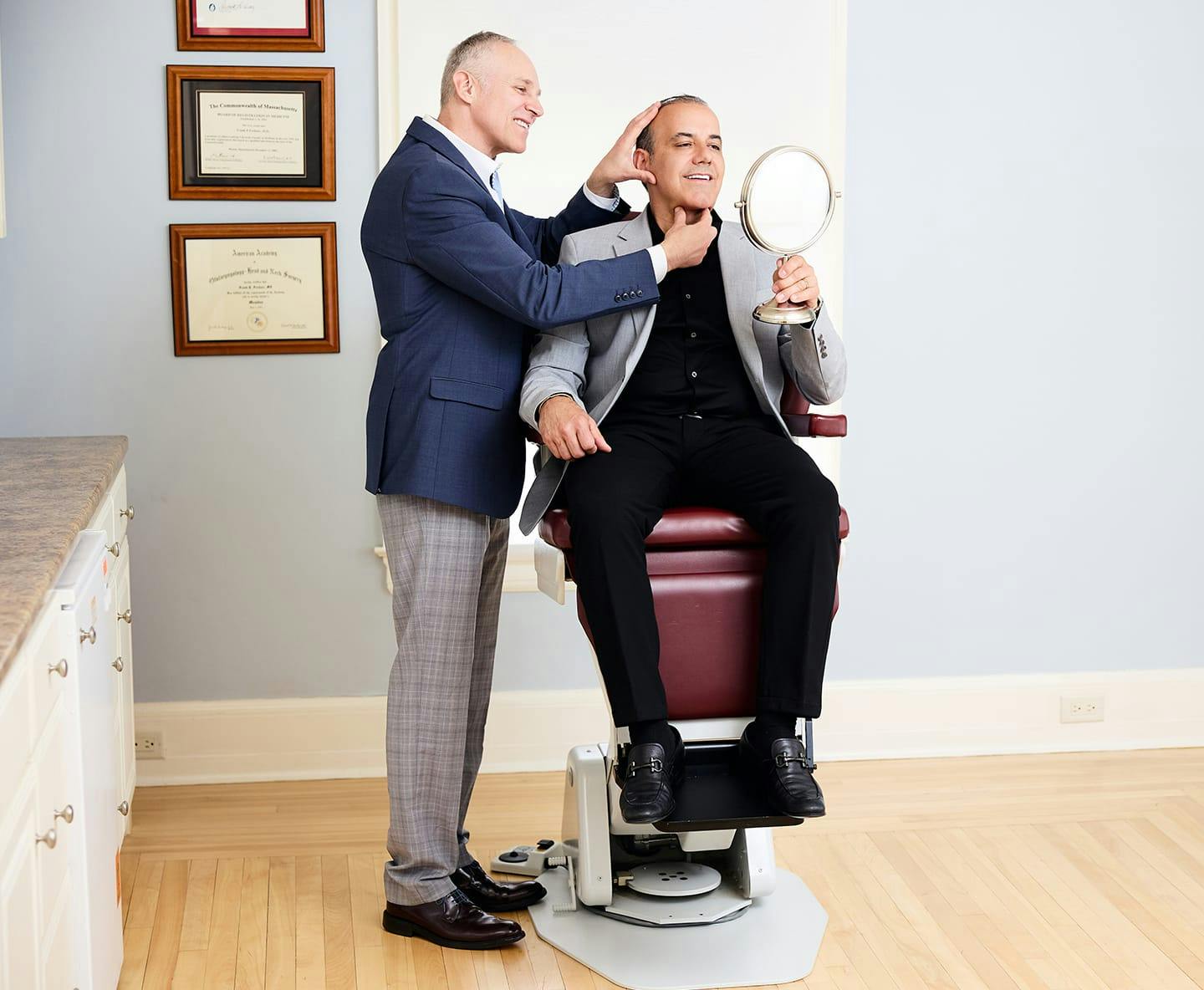 Dr. Fechner working with male patient while he sits in seat