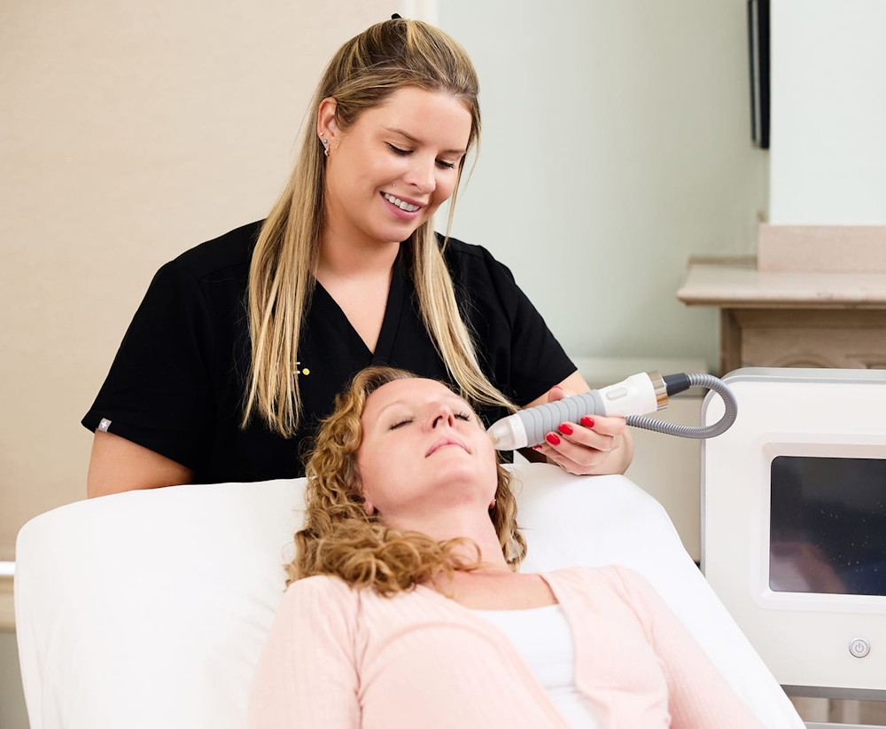 patient laying in chair with nurse behind the seat with machine in her hand