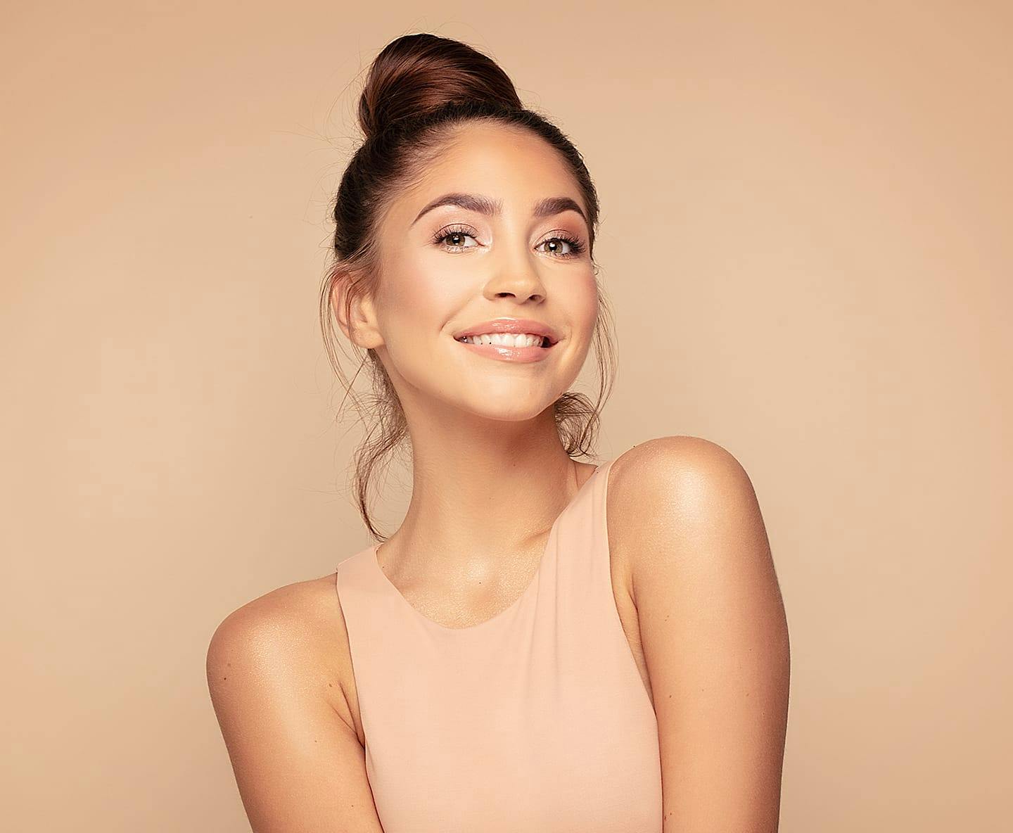 woman with hair in bun smiling
