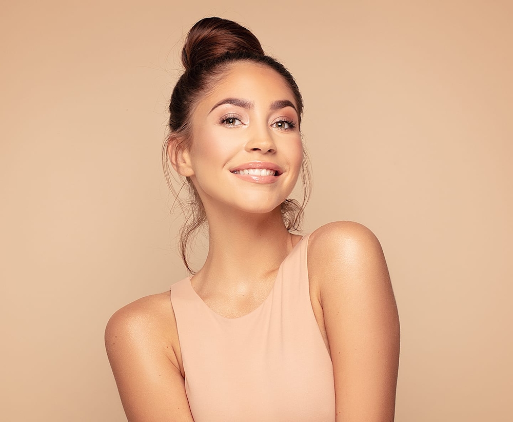 woman with hair in bun smiling