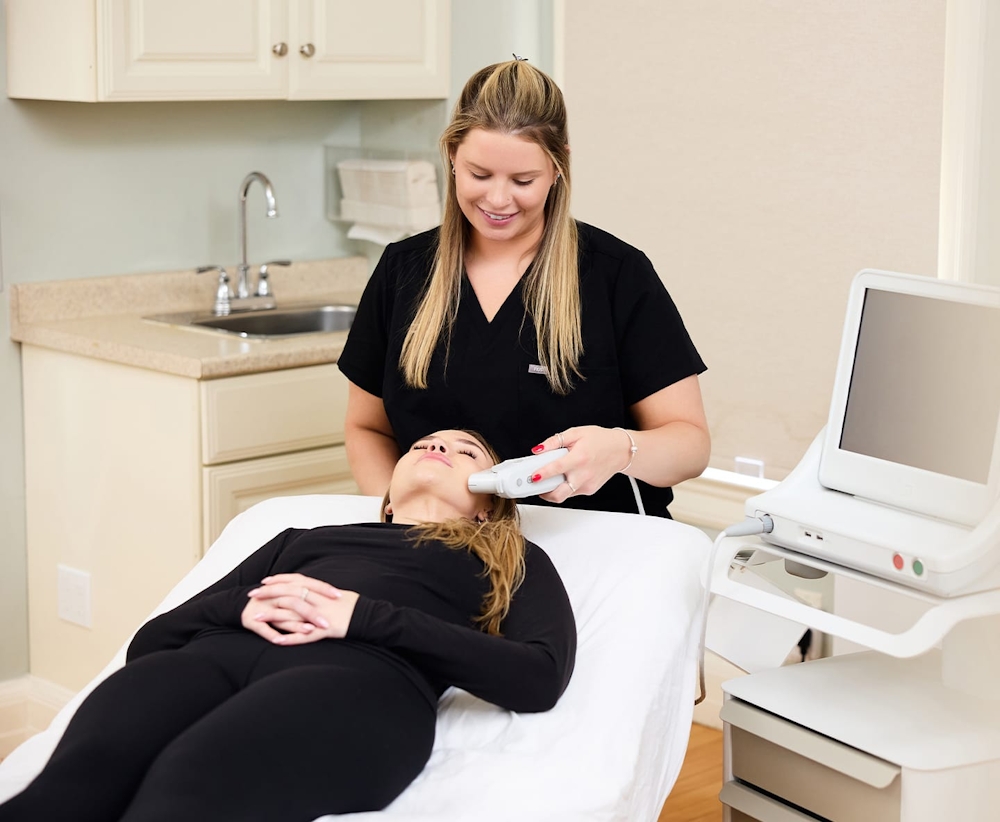 patient laying down while nurse is doing photofacial procedure on her