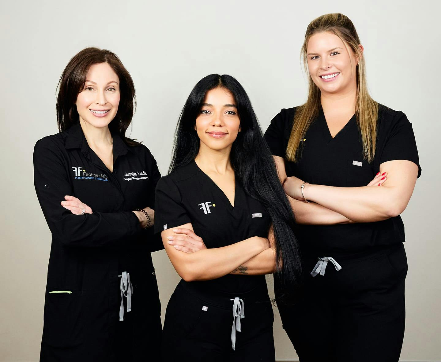 3 nurses smiling and crossing their arms