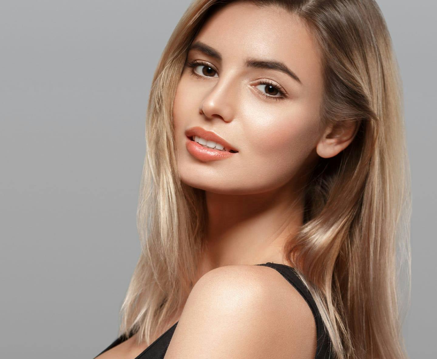 blonde woman looking over shoulder