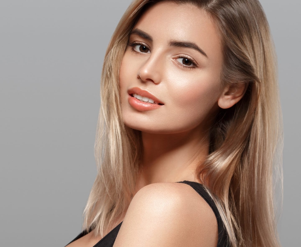 blonde woman looking over shoulder