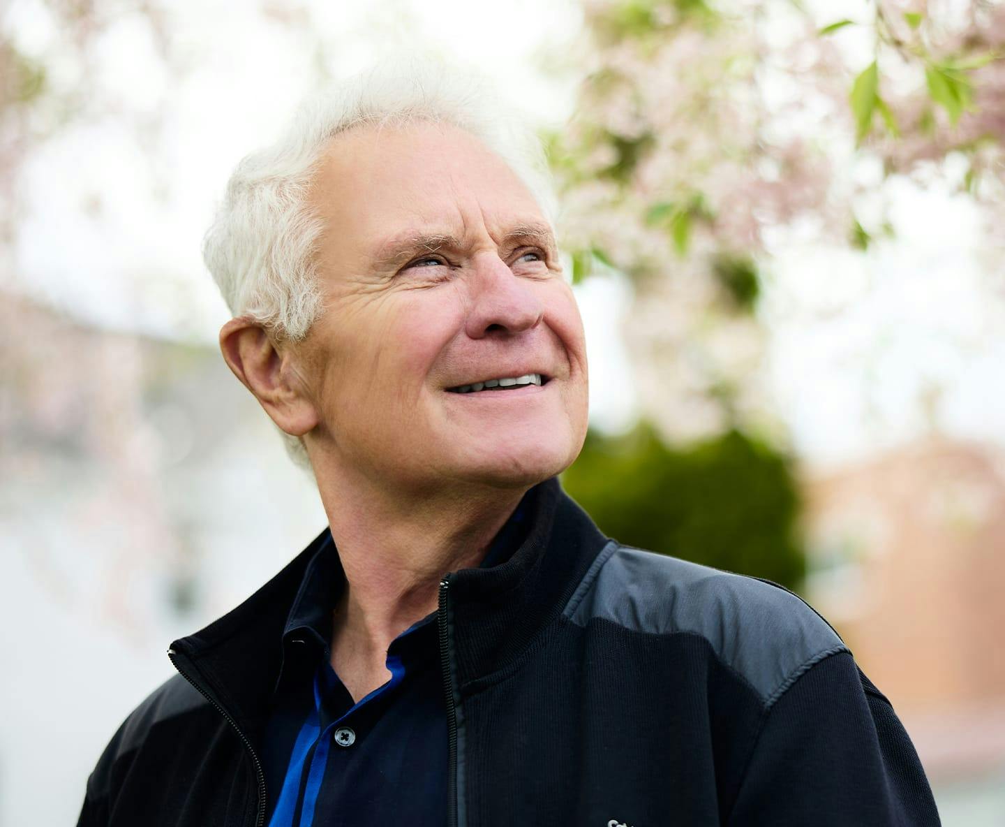 older man in jacket looking to the right